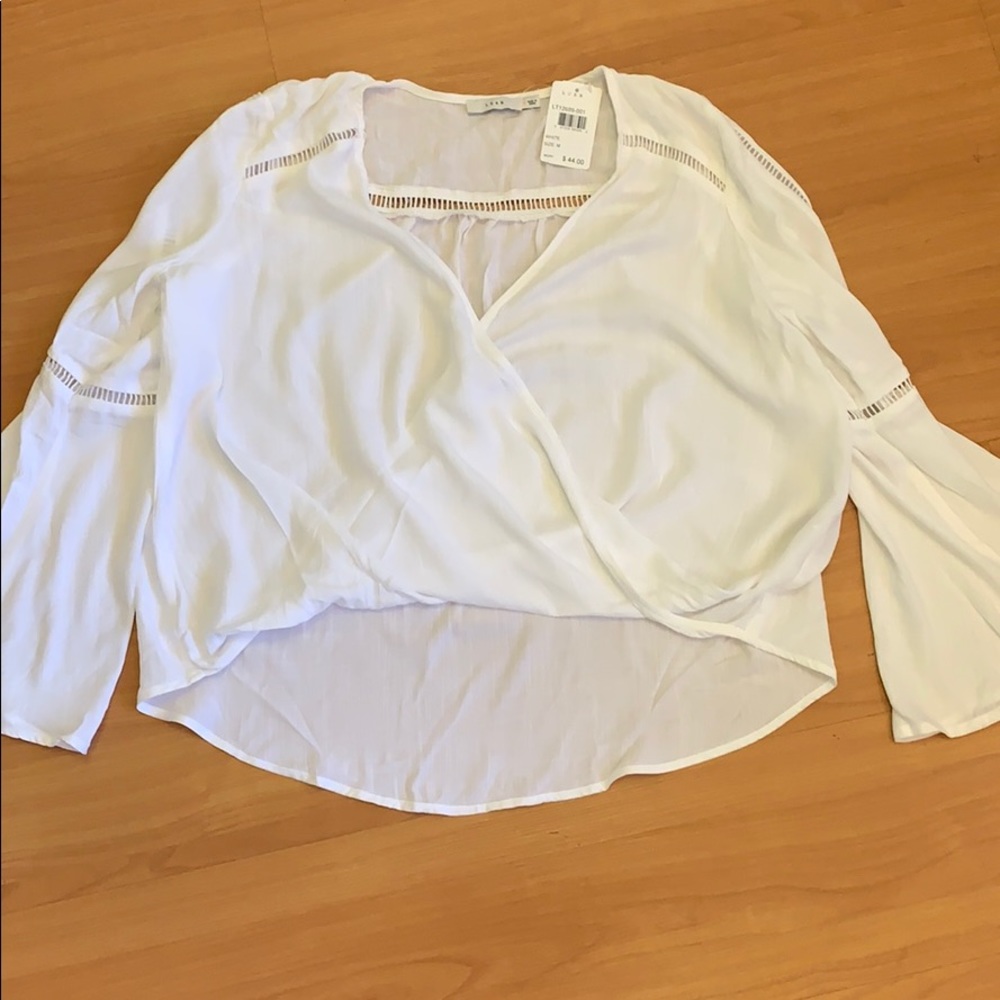 Brand new, white blouse with front button snap.